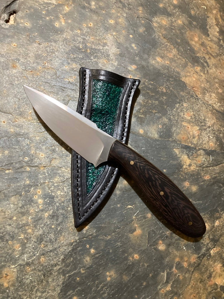 Small false edge hunter with false edge and pocket sheath